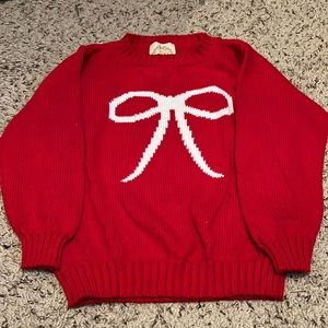 The Beaufort Bonnet Company red Holiday sweater with white bow detail.